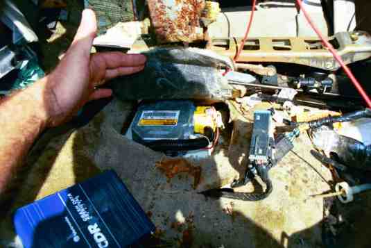 Extracting information from a black box in a vehicle This image shows a person Extracting information from a black box in a vehicle