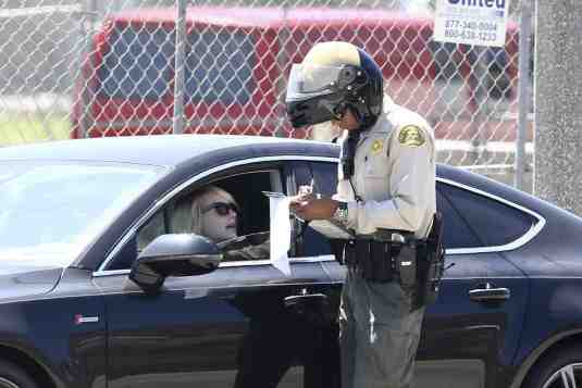 a police officer pulling over an uninsured motorist a police officer pulling over an uninsured motorist