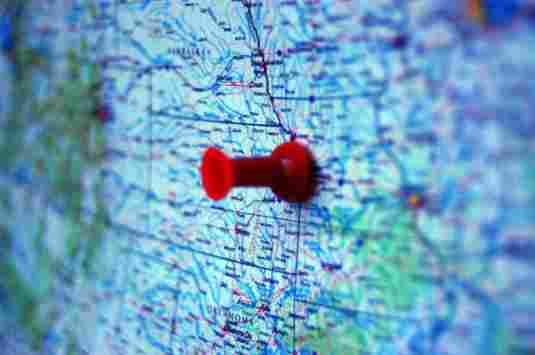 Showing a red pin on a map for planning a future road trip Showing a red pin on a map for planning a future road trip