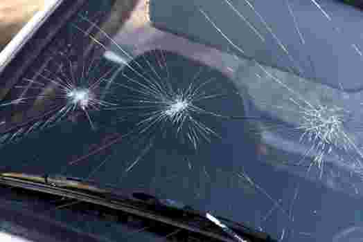 Star break type cracks on a damaged windshield.
