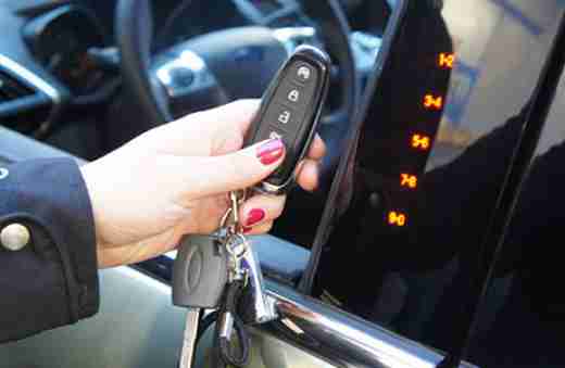 Driver remote starting a vehicle in cold weather. 