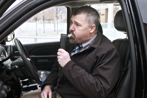 Driver using an IID in a vehicle.