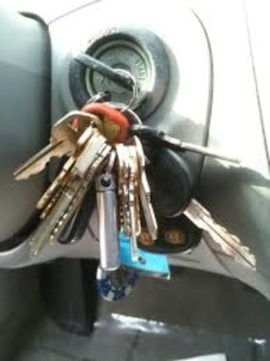 Keys hanging from an ignition switch in a vehicle. 